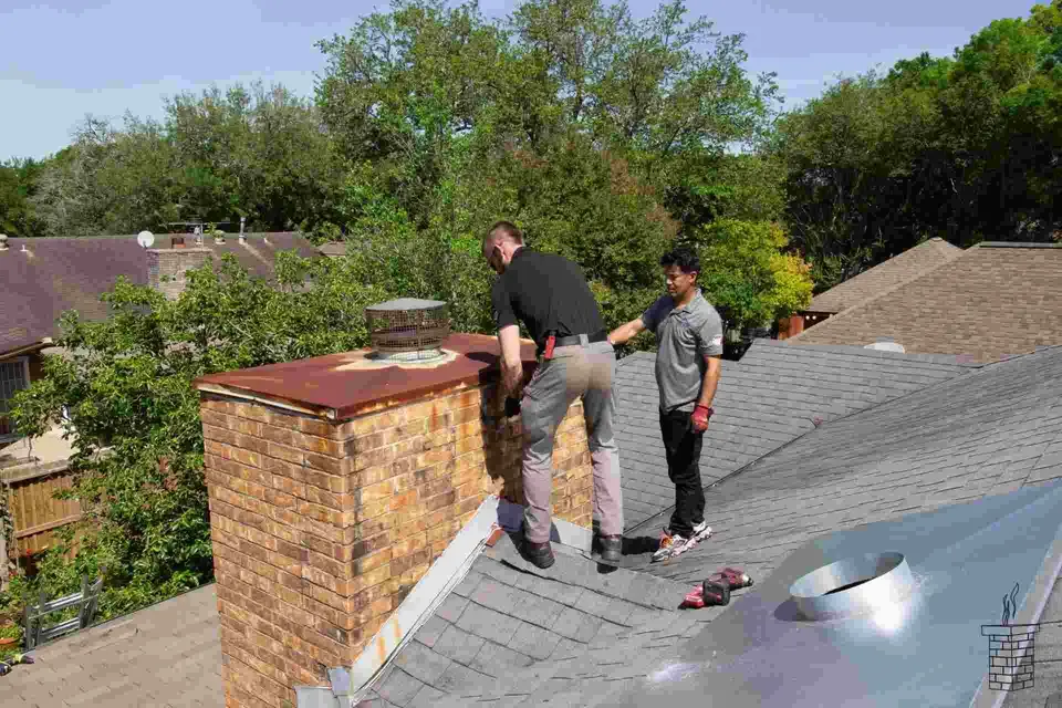 Chimney repair workers on roof -Texas Chimney LLC