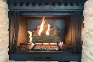 Gas fireplace with dark gray metal firebox by Texas Chimney LLC