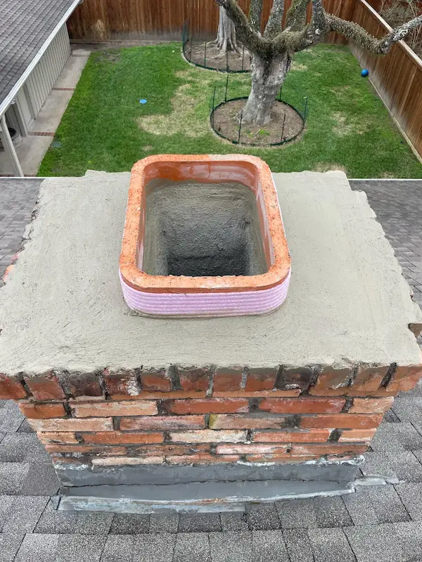 Top view of a freshly repaired chimney crown by Texas Chimney LLC in Houston.