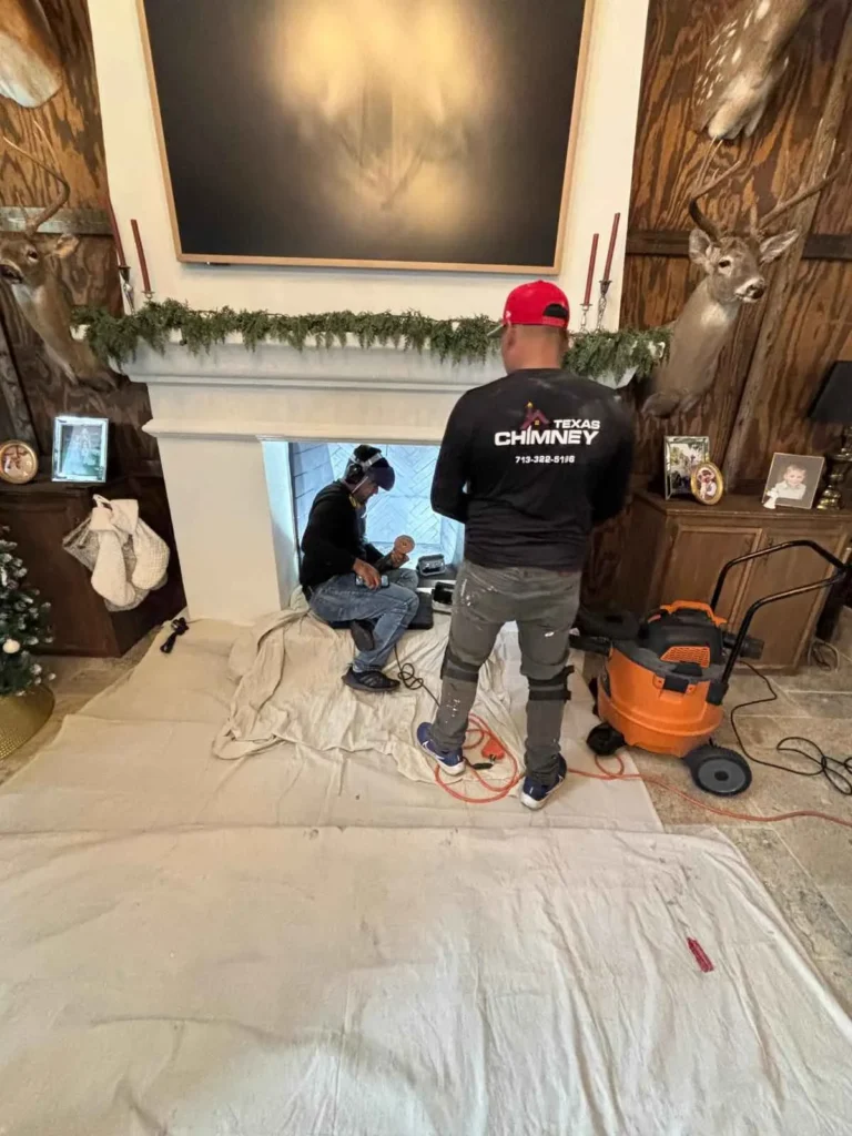 chimney professionals from Texas Chimney performing a service on a fireplace