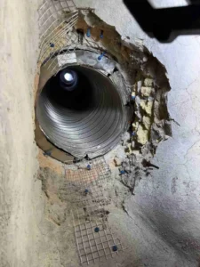 shows the installation of a corrugated metal pipe