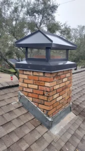 Newly installed chimney with a black cap on top